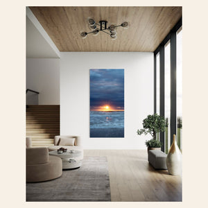 A Cannon Beach sunset picture hangs in a living room.