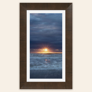 A framed Cannon Beach sunset picture.