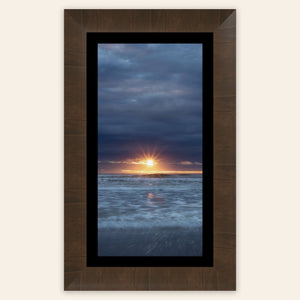 A framed Cannon Beach sunset picture.