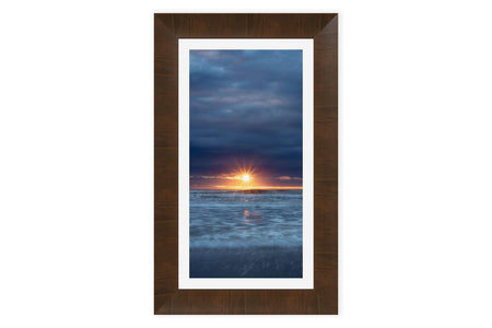 A framed Cannon Beach sunset picture.