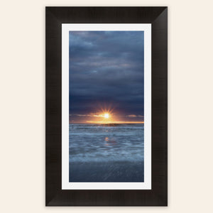 A framed Cannon Beach sunset picture.