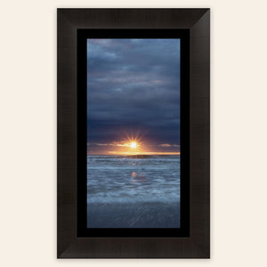 A framed Cannon Beach sunset picture.