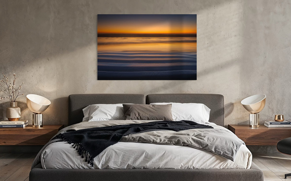 A Cannon Beach sunset photo hangs above a bed. | Lars Gesing Fine Art | Coastal Wall Art