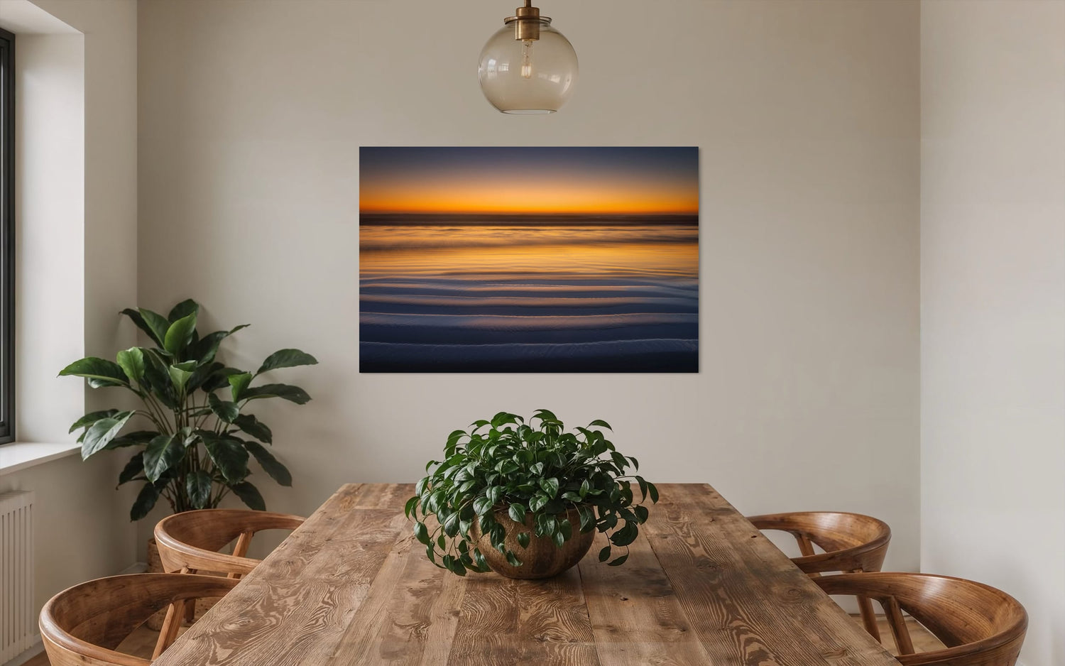 A Cannon Beach sunset photo hangs in a dining room. | Lars Gesing Fine Art | Coastal Wall Art