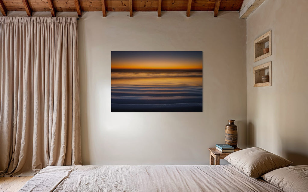 A Cannon Beach sunset photo hangs in a cozy bedroom. | Lars Gesing Fine Art | Coastal Wall Art