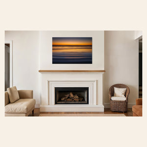 A Cannon Beach sunset photo hangs above a fireplace. | Lars Gesing Fine Art | Coastal Wall Art