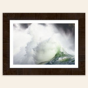 A piece of framed Washington wall art shows the waves at Cape Disappointment.