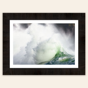 A piece of framed Washington wall art shows the waves at Cape Disappointment.