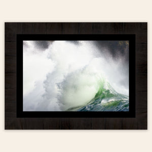 A piece of framed Washington wall art shows the waves at Cape Disappointment.