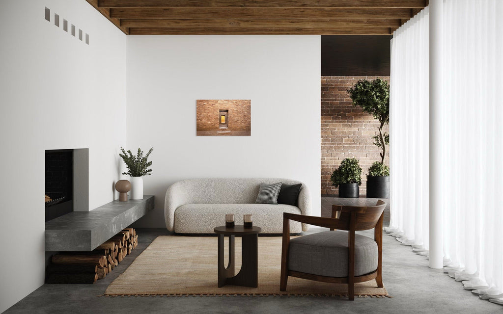 A piece of New Mexico art showing a Chaco Canyon photo hangs above a couch.