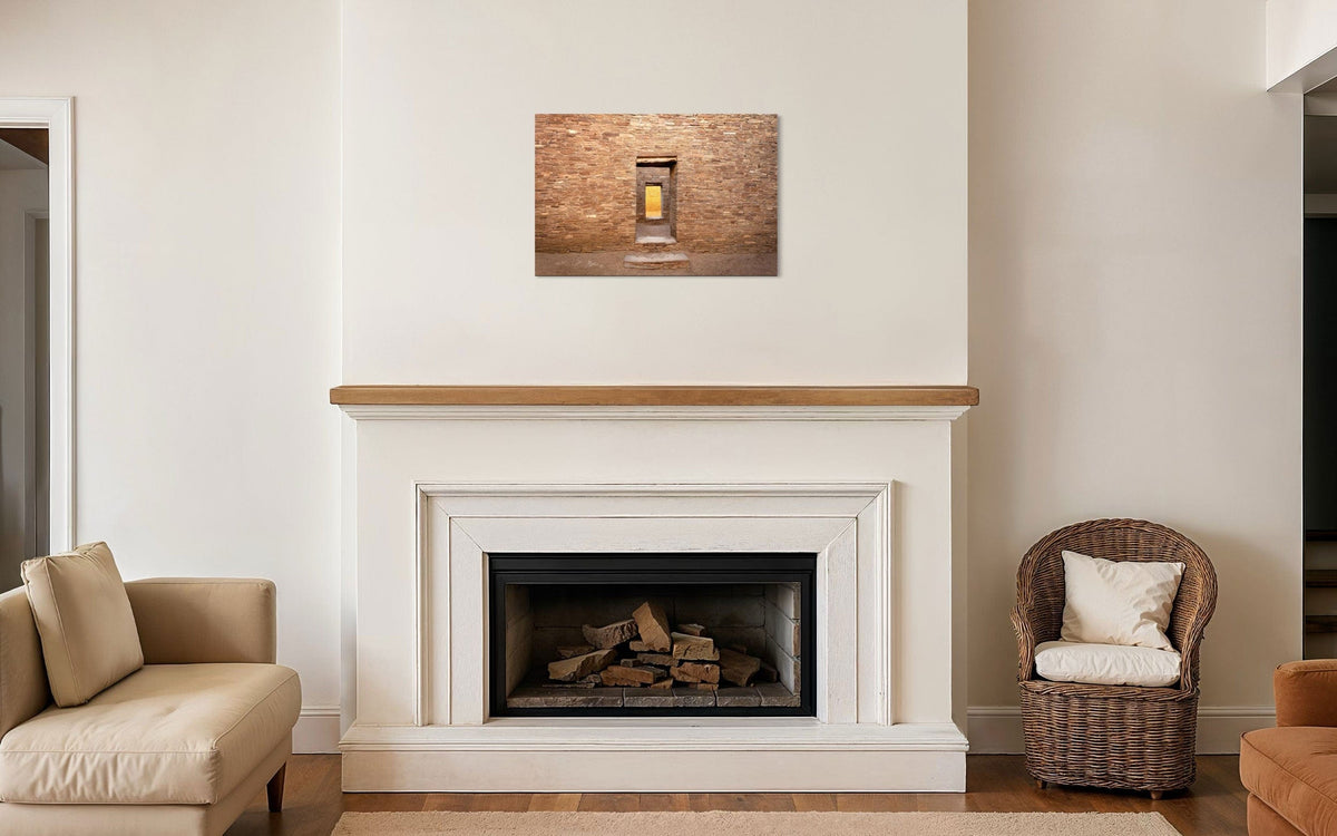 A piece of New Mexico art showing a Chaco Canyon photo hangs above a fireplace.