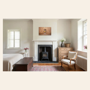 A piece of New Mexico art showing a Chaco Canyon photo hangs in a bedroom.