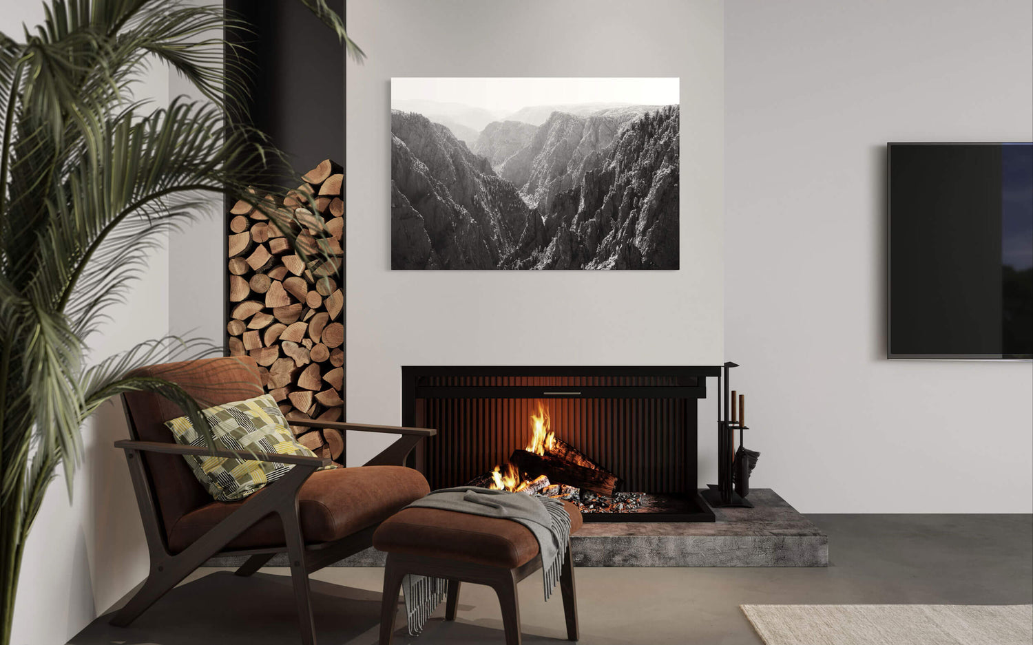 A piece of black and white Colorado art showing the Black Canyon of the Gunnison hangs in a living room.