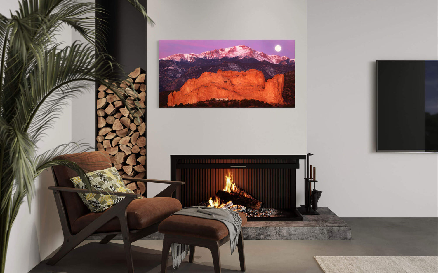 A piece of Colorado Springs art showing Pikes Peak behind the Garden of the Gods hangs in a living room.
