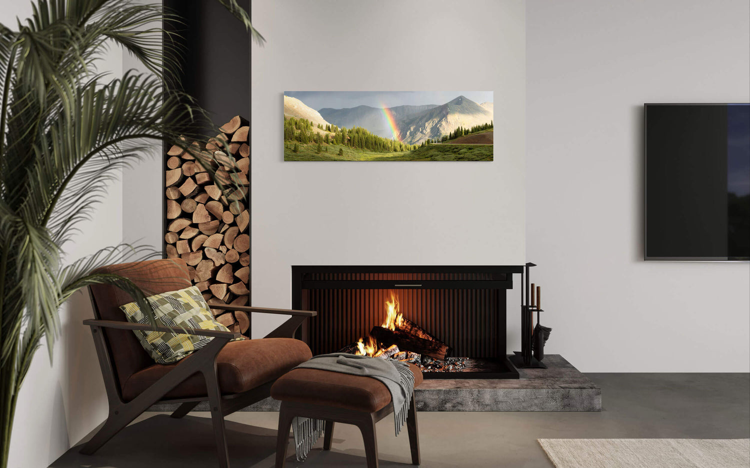 A piece of Colorado art showing a rainbow on Cottonwood Pass hangs in a living room.