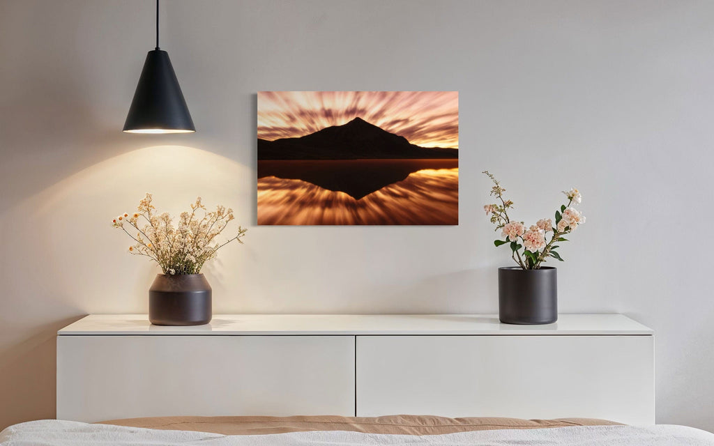 A piece of Crested Butte art showing a photo of the mountain at sunrise from Peanut Lake hangs in a dining area.