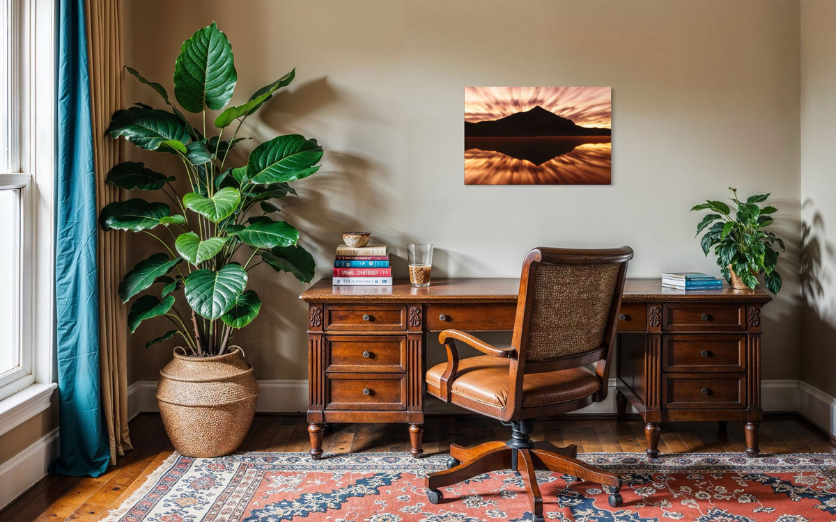 A piece of Crested Butte art showing a photo of the mountain at sunrise from Peanut Lake hangs in an office.