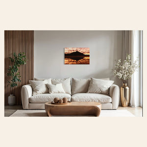 A piece of Crested Butte art showing a photo of the mountain at sunrise from Peanut Lake hangs above a couch.