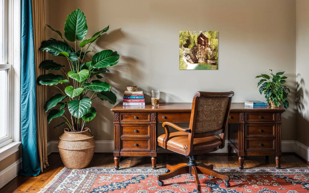 A piece of Colorado art showing a Crystal Mill photo hangs in an office.