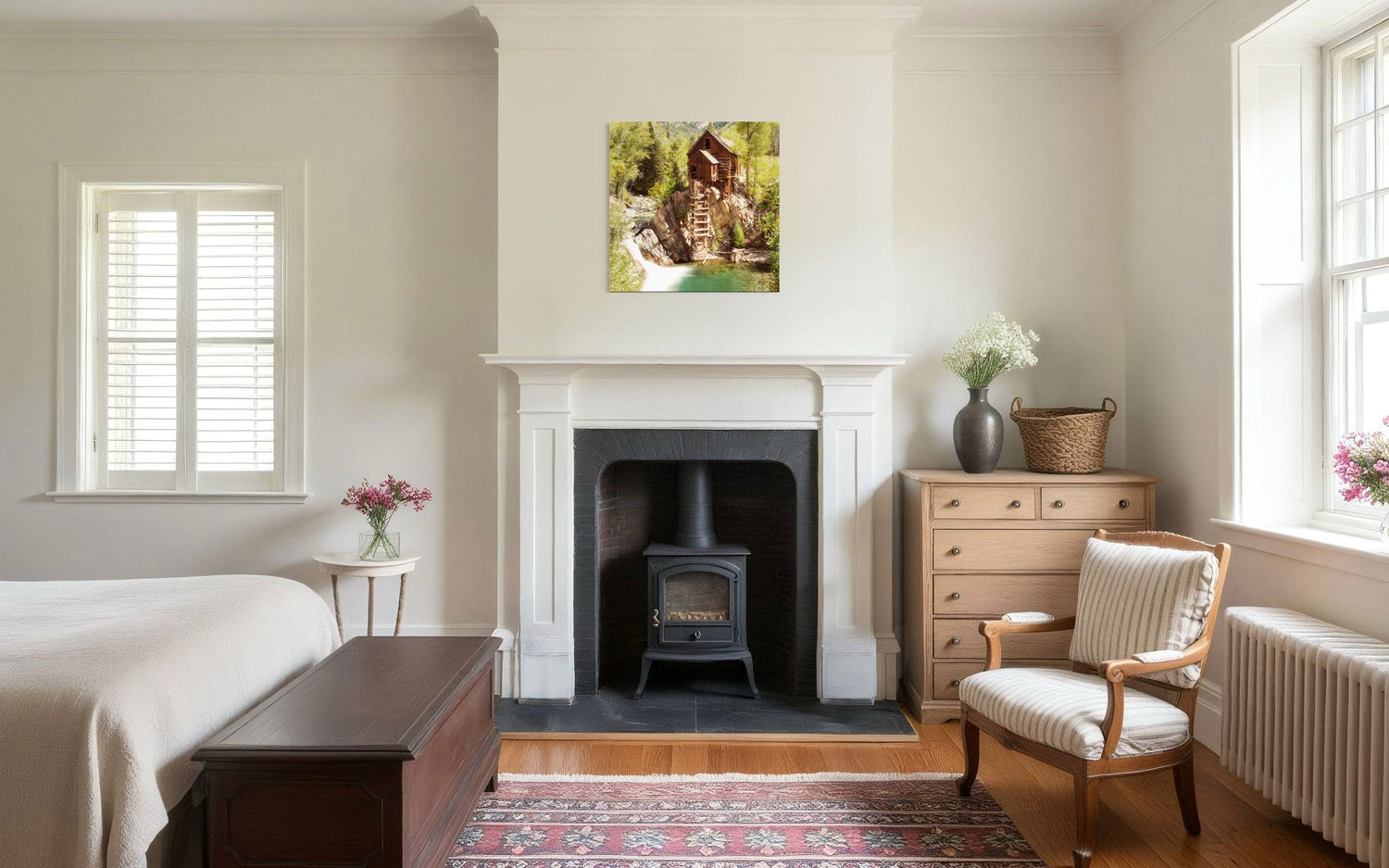 A piece of Colorado art showing a Crystal Mill photo hangs above a fireplace.