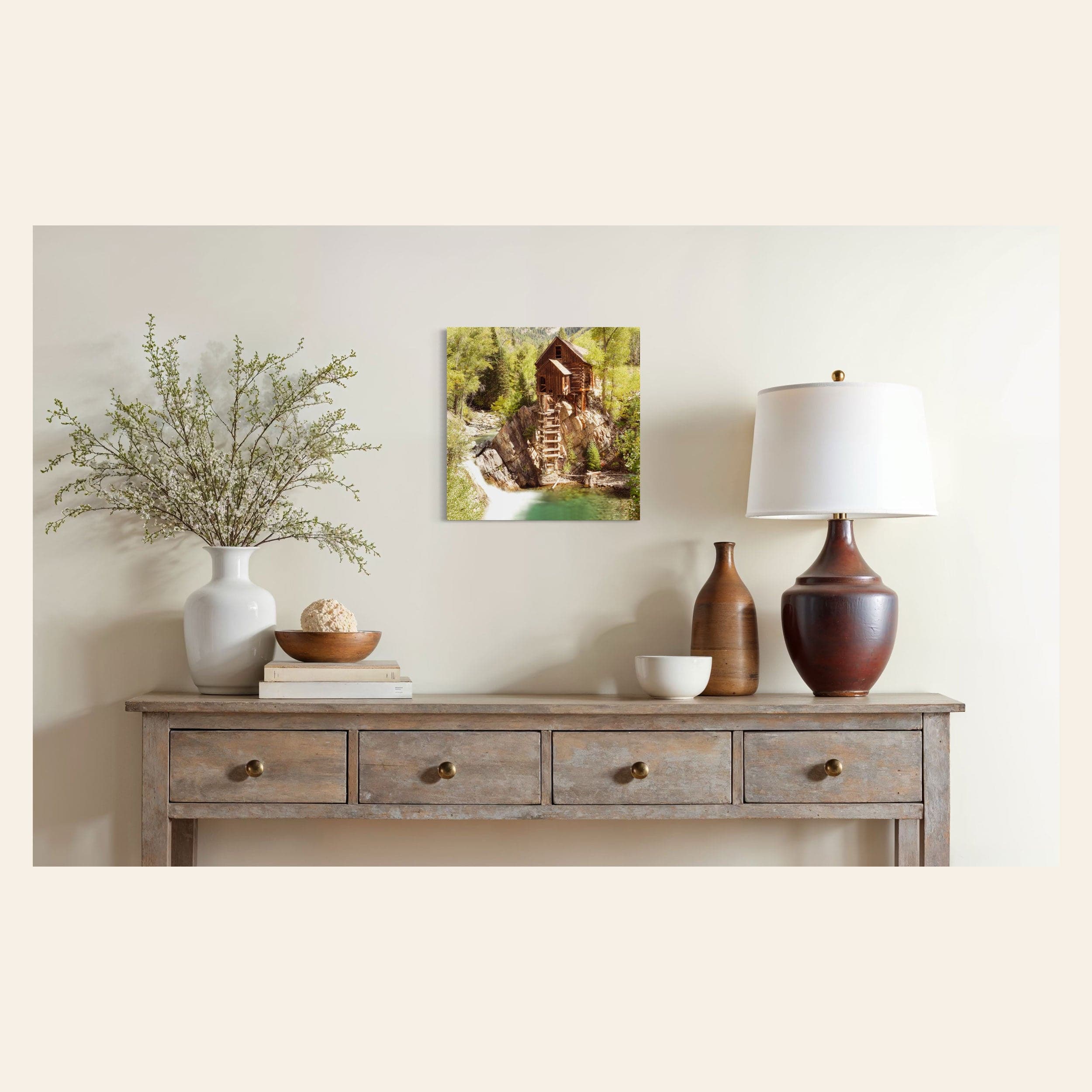 A piece of Colorado art showing a Crystal Mill photo hangs in a dining room.