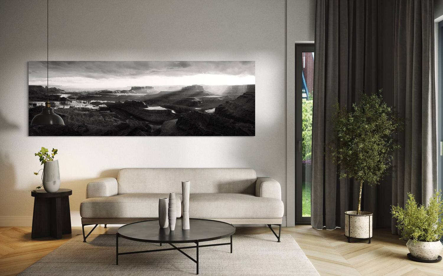 A piece of black and white panorama wall art from Dead Horse Point in Utah hangs in a living room.