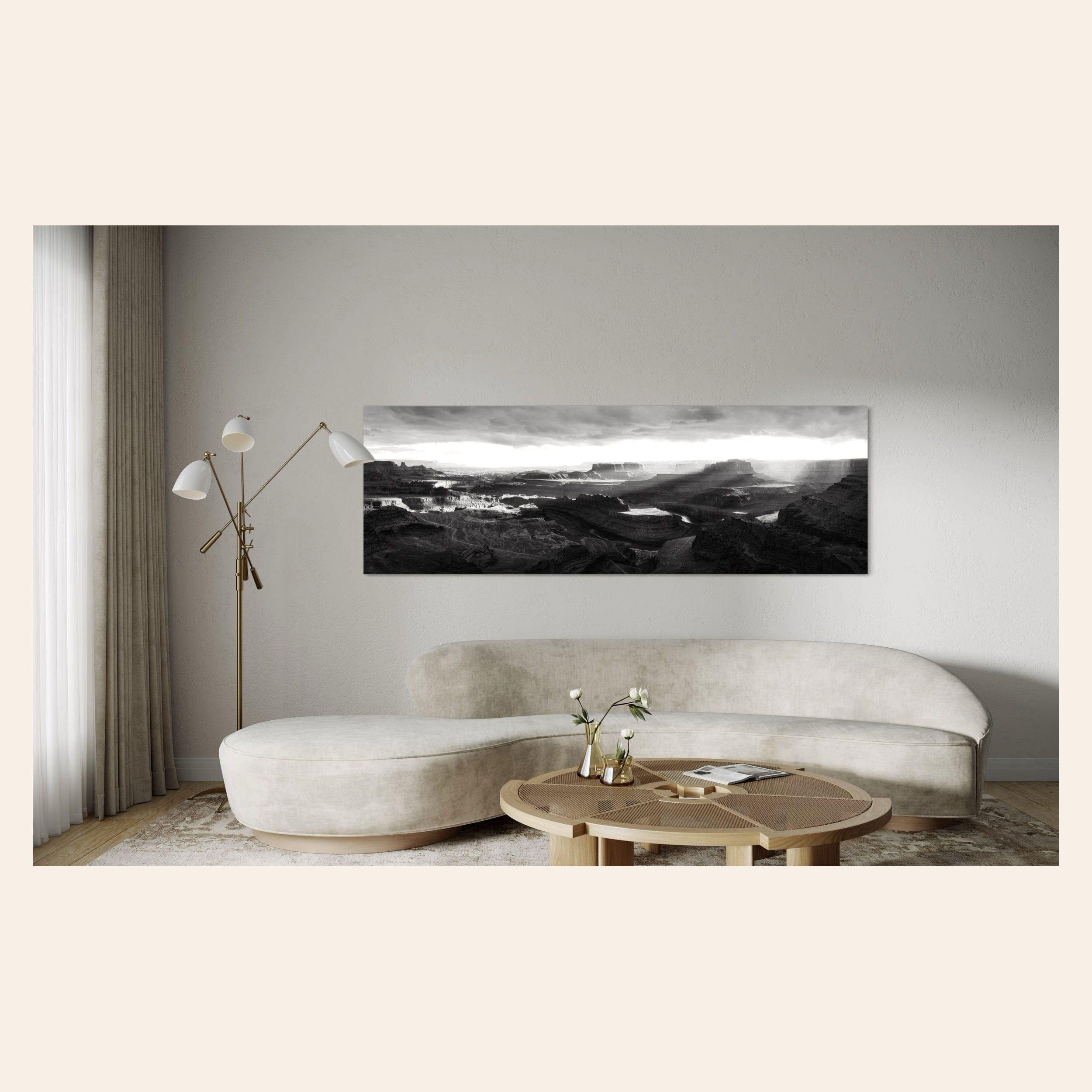 A piece of black and white panorama wall art from Dead Horse Point in Utah hangs in a living room.