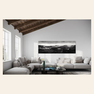 A piece of black and white panorama wall art from Dead Horse Point in Utah hangs in a living room.