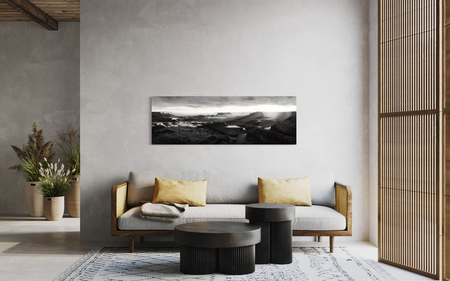 A black and white panorama Dead Horse Point State Park picture hangs in a living room.