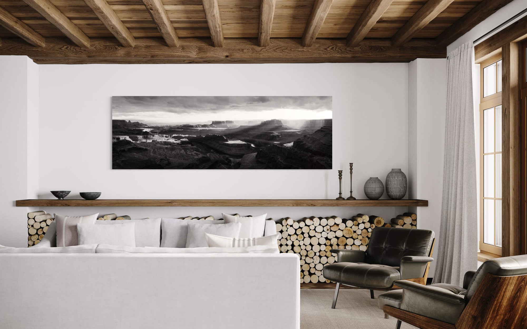 A black and white panorama Dead Horse Point State Park picture hangs in a living room.