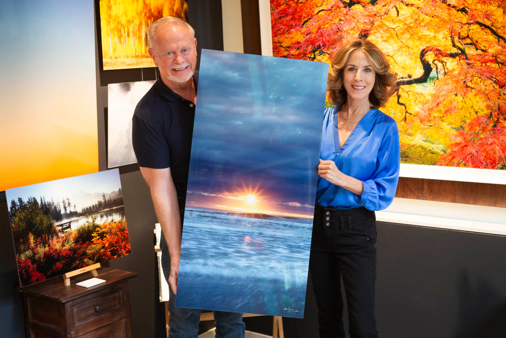 Collectors with a piece of Cannon Beach art in Lars Gesing's West Seattle gallery.