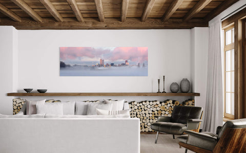 A picture of Denver City Park during a sunrise in winter hangs in a living room.