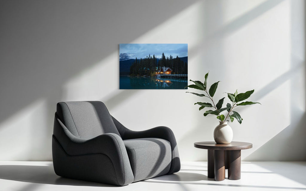 A piece of Banff art showing an Emerald Lake Lodge photo hangs next to a comfy chair.