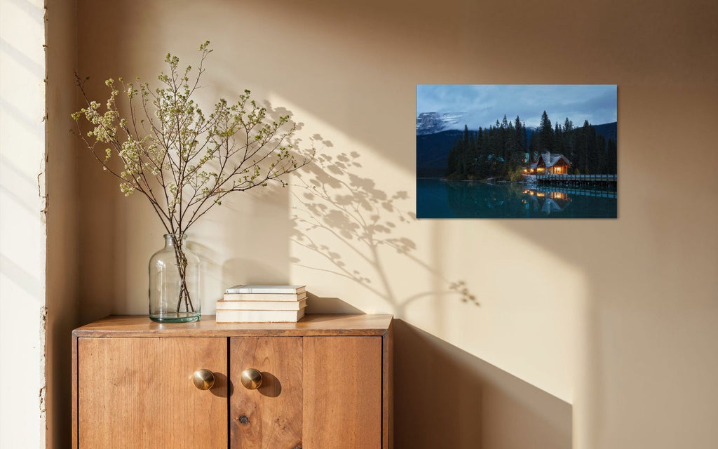A piece of Banff art showing an Emerald Lake Lodge photo hangs in a home.