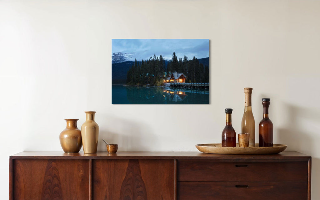 A piece of Banff art showing an Emerald Lake Lodge photo hangs over a console.
