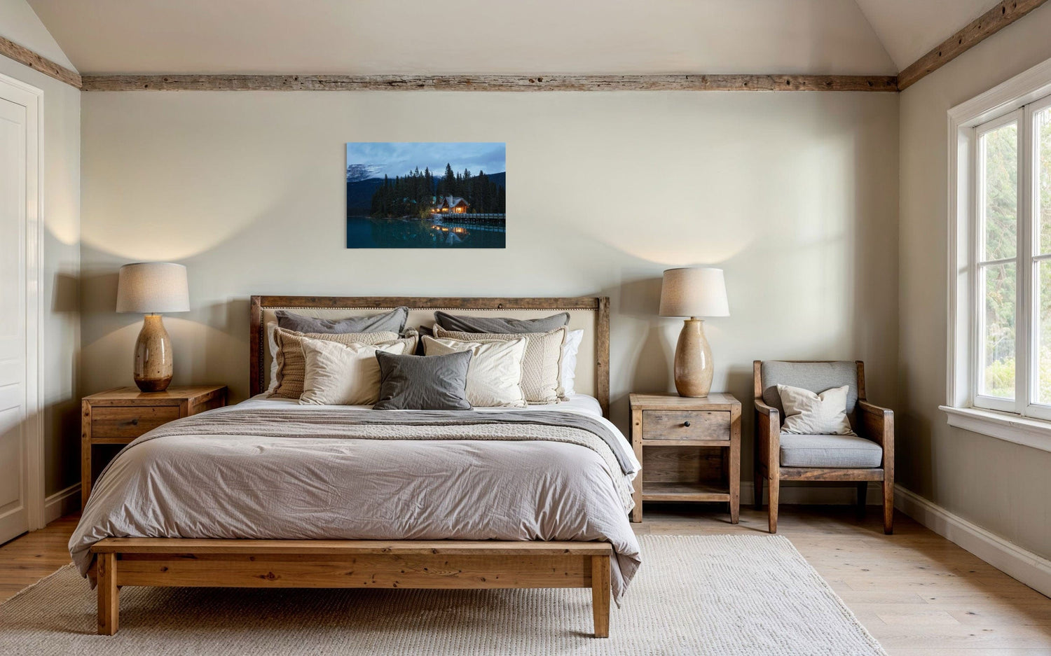 A piece of Banff art showing an Emerald Lake Lodge photo hangs above a bed.