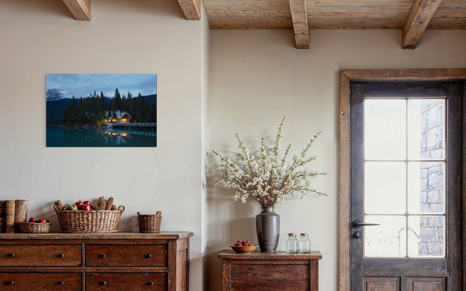 A piece of Banff art showing an Emerald Lake Lodge photo hangs in an entryway.