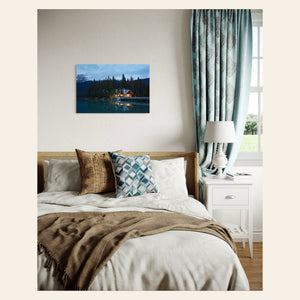 A piece of Banff art showing an Emerald Lake Lodge photo hangs in a bedroom.