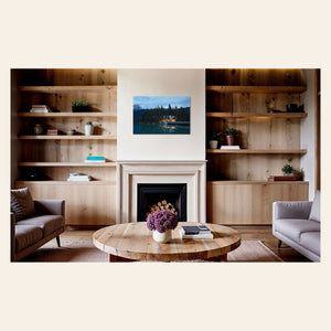 A piece of Banff art showing an Emerald Lake Lodge photo hangs above a fireplace.