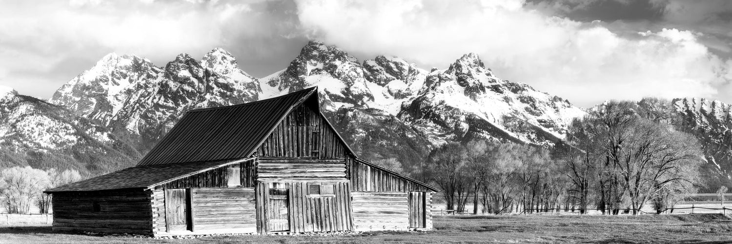 A black and white photograph of the famous Mormon barn in Grand Teton National Park.