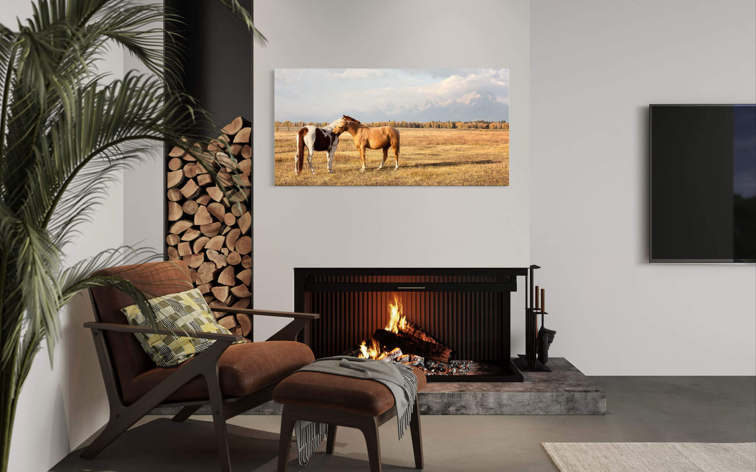 A piece of Jackson Hole art showing horses in Grand Teton National Park hangs in a living room.
