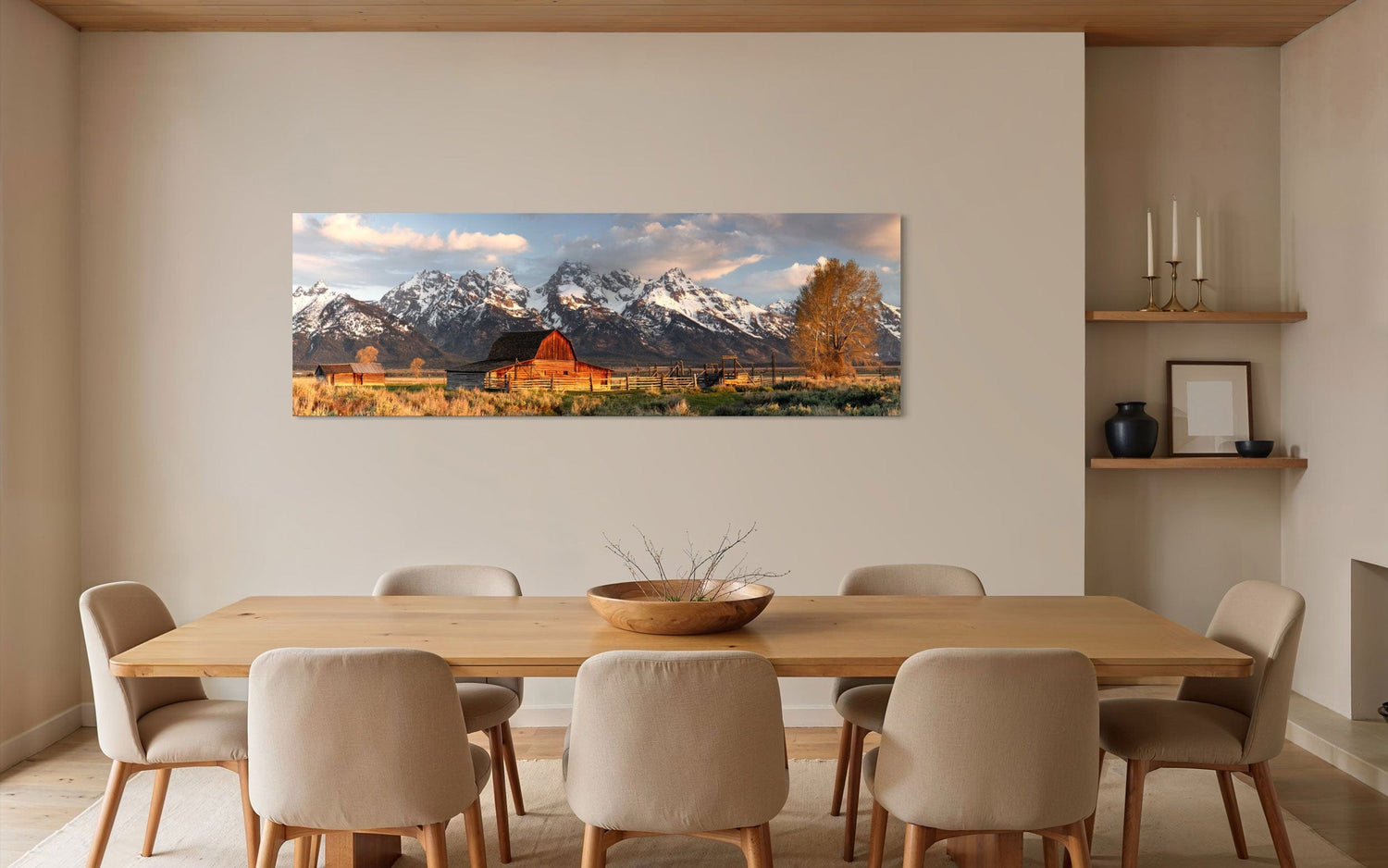 A piece of Jackson Hole art showing a photo of Mormon Row at the foot of the Grand Tetons hangs in a dining area.