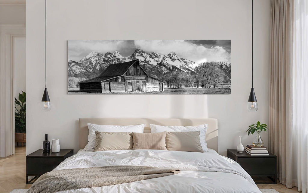 A piece of black and white wall art from Grand Teton National Park hangs in a bedroom.