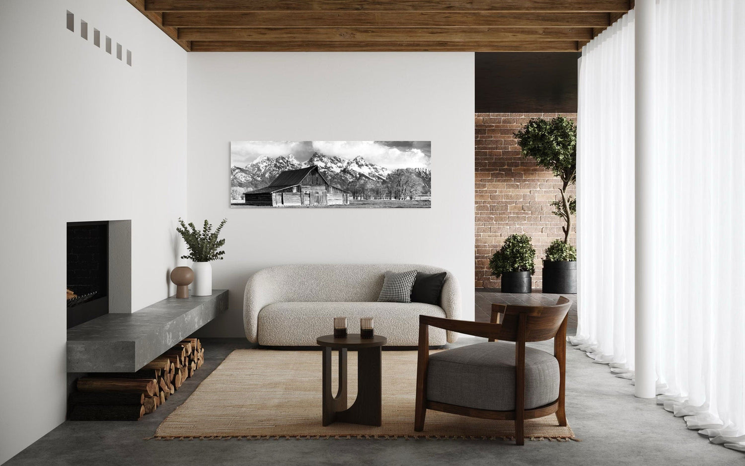 A piece of black and white wall art from Grand Teton National Park hangs in a rustic modern living room.