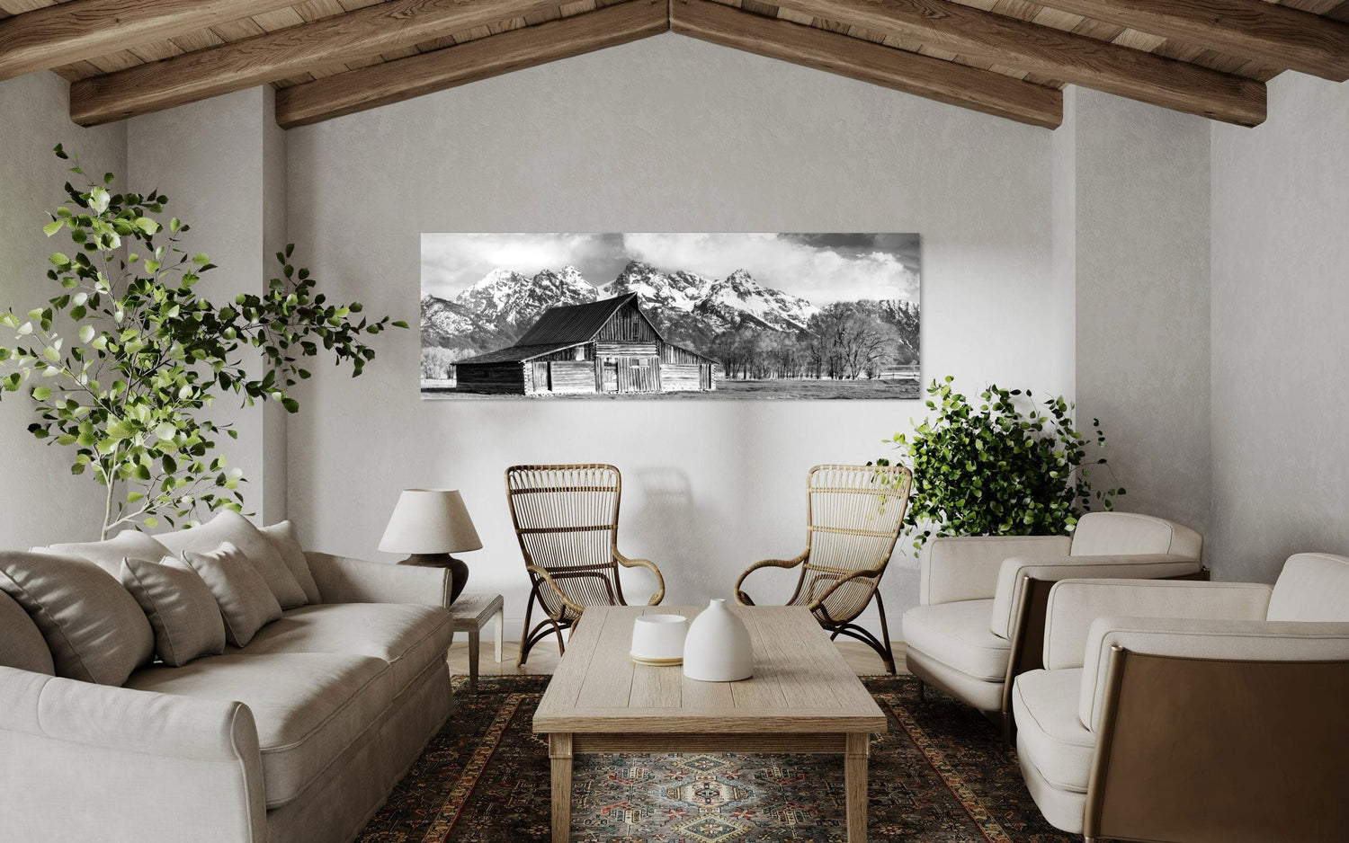 A piece of black and white wall art from Grand Teton National Park hangs in a living room with vaulted ceilings.