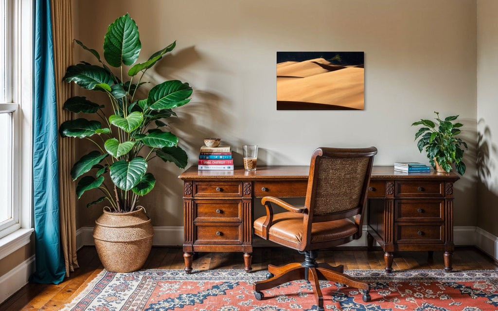 A piece of Colorado art showing a photo of Great Sand Dunes National Park hangs in an office.