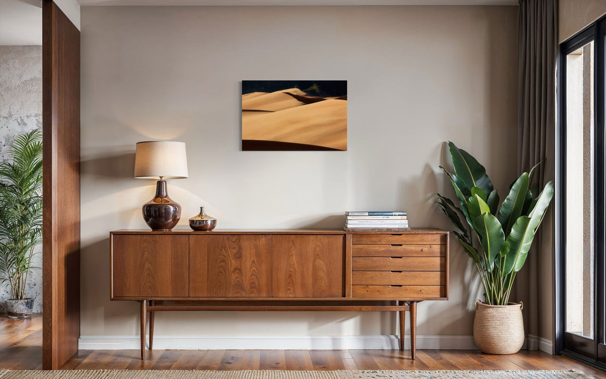 A piece of Colorado art showing a photo of Great Sand Dunes National Park hangs in a midcentury modern home.