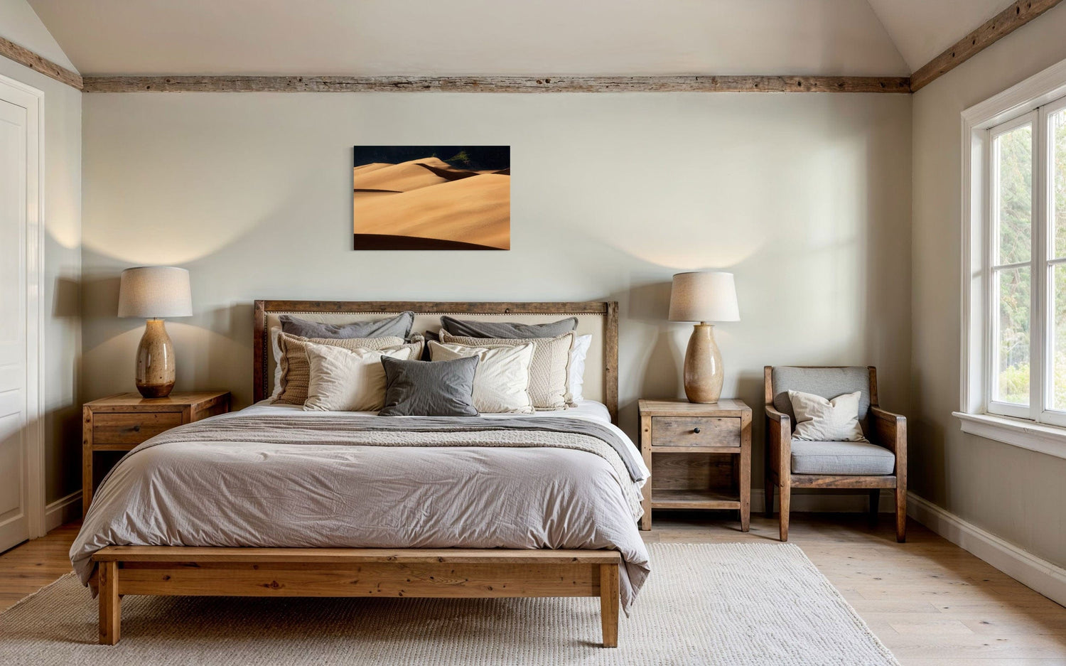 A piece of Colorado art showing a photo of Great Sand Dunes National Park hangs in a bedroom.