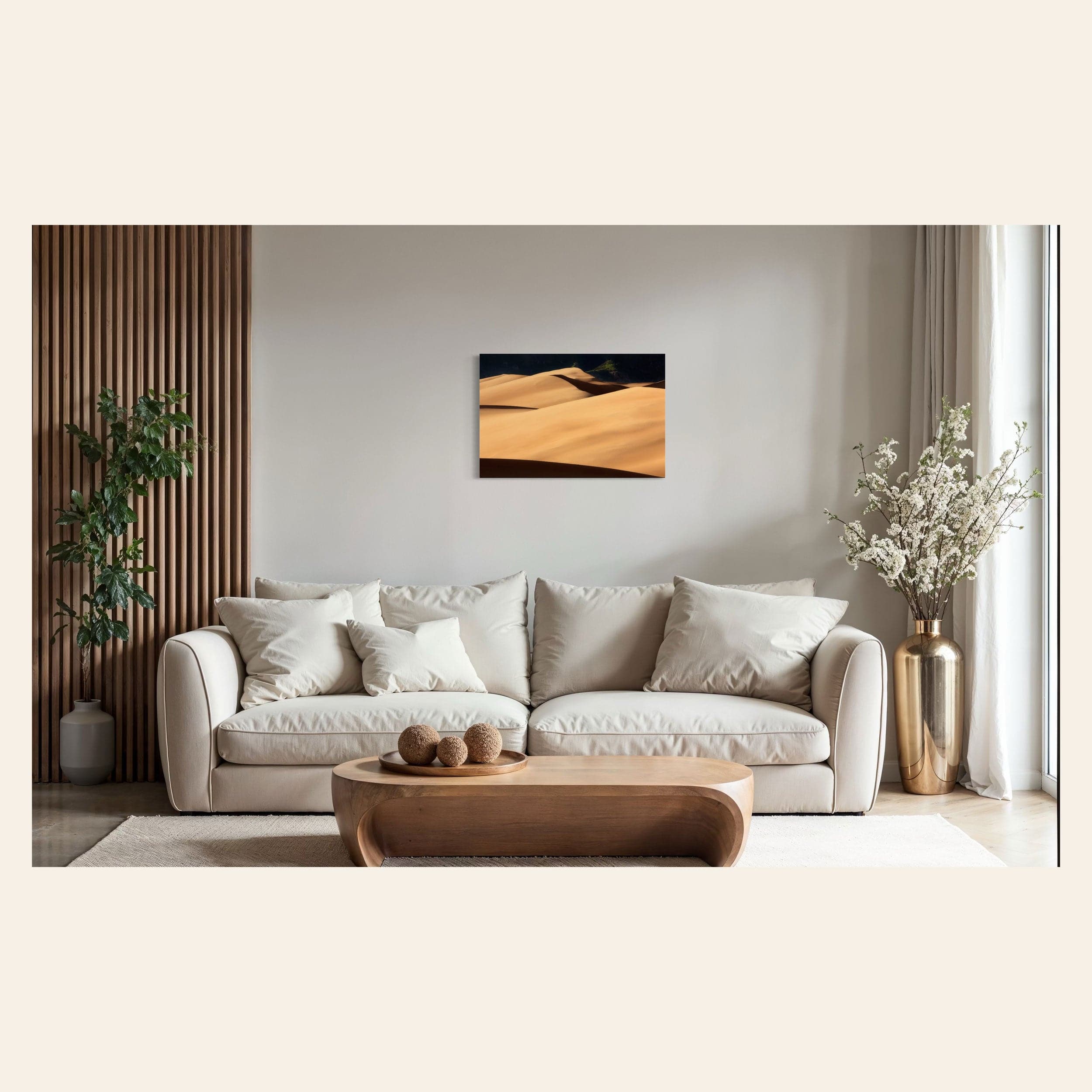 A piece of Colorado art showing a photo of Great Sand Dunes National Park hangs above a couch.