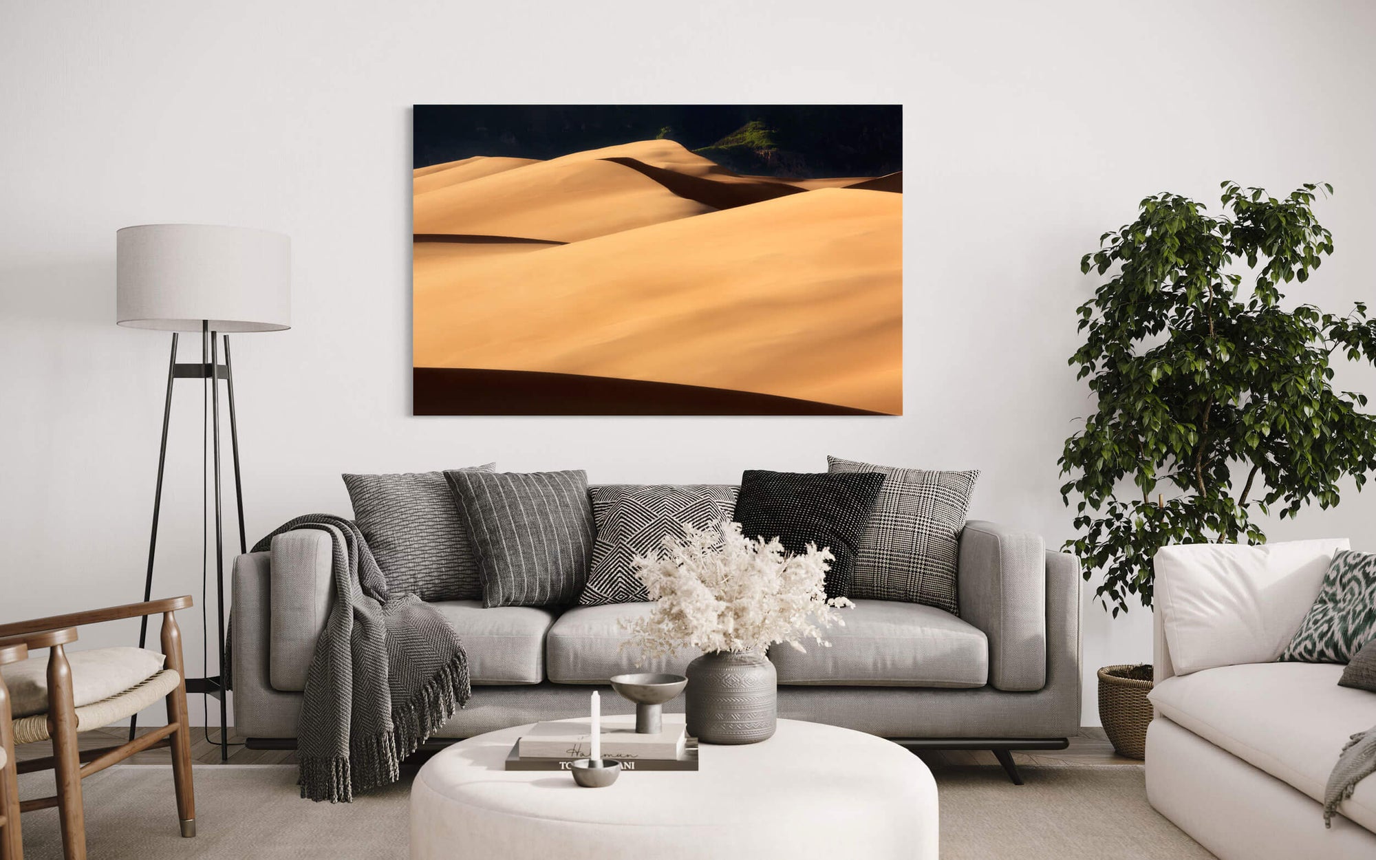 A piece of Colorado art showing a Great Sand Dunes National Park picture hangs in a living room.